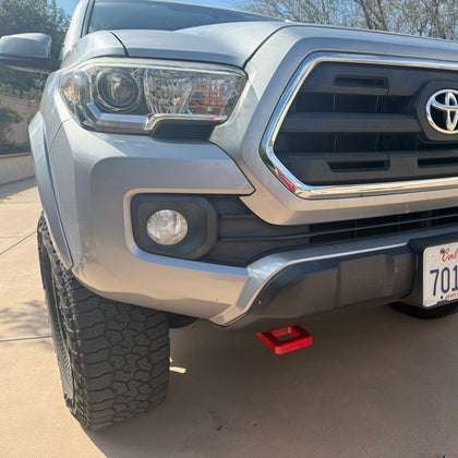 Front view of a Toyota truck with California license plate on a driveway.