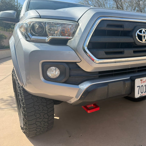 Front view of a Toyota truck with California license plate on a driveway.